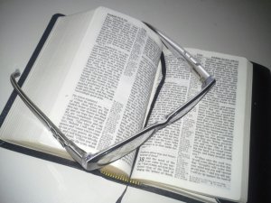 Open bible with reading glasses