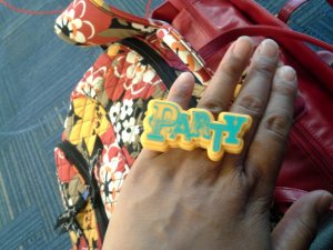 Roshaunda wearing a ring that was used as a cupcake decoration.  The ring reads "Party."