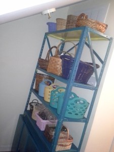 Wall shelf filled with an assortment of baskets