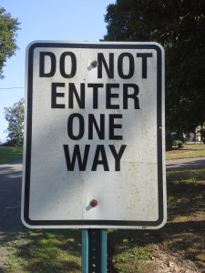 Black and white "Do Not Enter -- One Way" sign