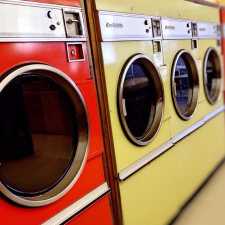 Machines in a laundromat by Wokandapix on Pixabay at https://pixabay.com/en/laundromat-washer-dryer-machine-928779/