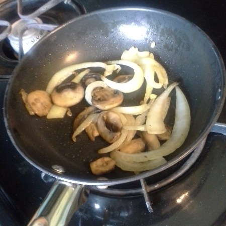Mushrooms and onions in a skillet
