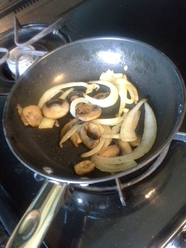 Mushrooms and onions in a skillet