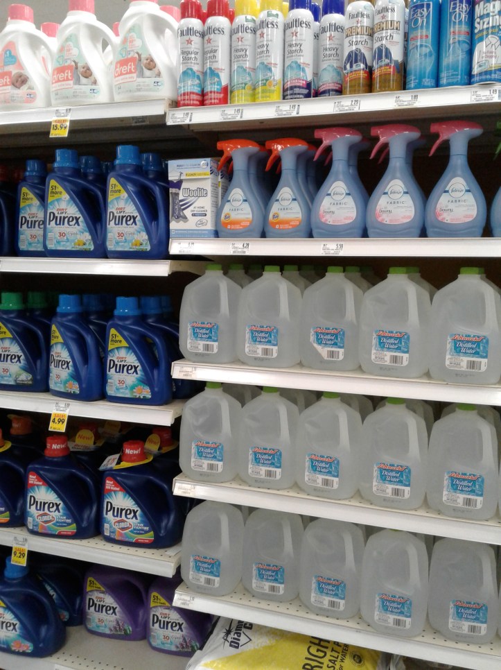 Bottled water in detergent aisle at grocery store